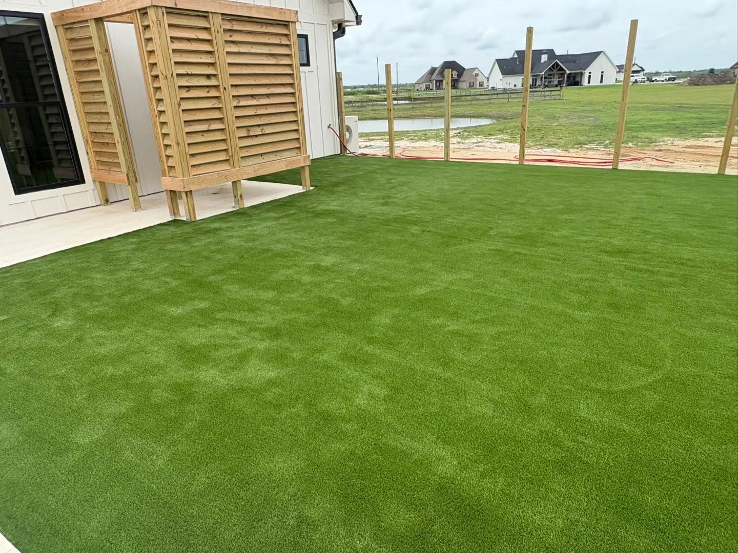 Fresh turf installation on new construction backyard